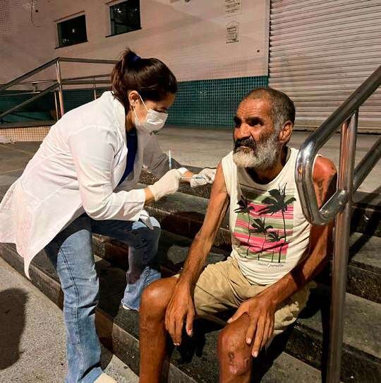 Profissional vacina homem em situação de rua